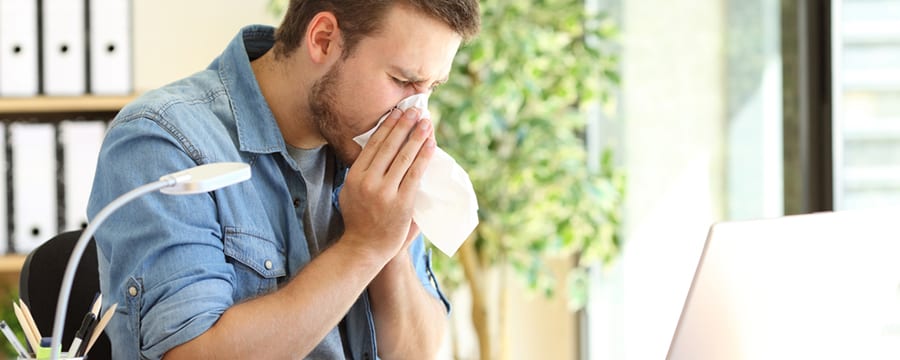 Man Sneezing Due to Allergies